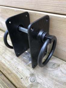 Pair off rustic large black rings as door closers/gate closers, beautifully nostalgic.