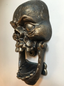 Cast iron bronze skull as door knocker.