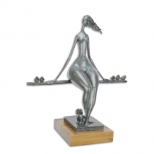 A bronze statue/sculpture of a relaxing naked woman