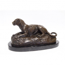 A bronze statue/sculpture of a lying lioness