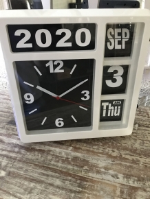 A clock with year, date and time, with stand, but can also hang on the wall, white