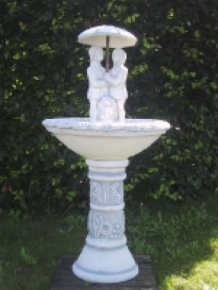 Garden fountain full of stone with children under an umbrella, great!