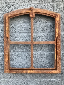 An antique-looking stable window, foldable open, untreated cast iron, resting surface, window