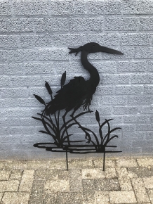 A silhouette of a heron, matte black