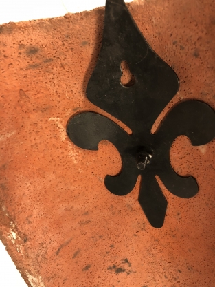 Wind light of roof tile with mythical image, with candlestick and glass flask.