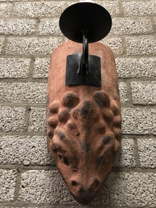 Wind light from roof tile with mythical image, with candlestick.