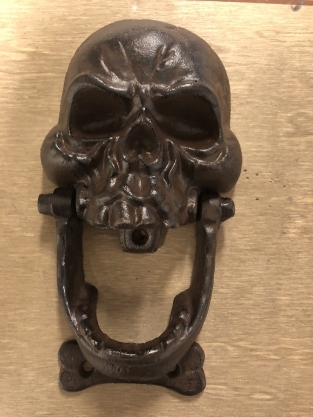 Cast iron brown skull as door knocker.