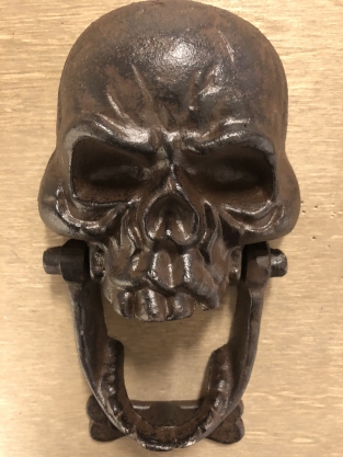 Cast iron brown skull as door knocker.