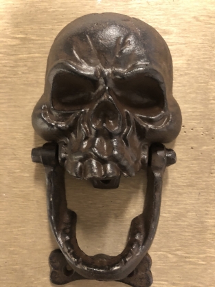 Cast iron brown skull as door knocker.