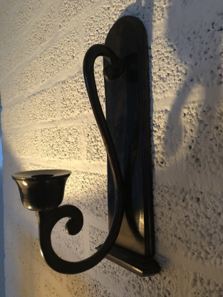 Beautiful dark brown heavy wrought iron wall sconce.