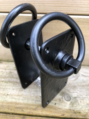 Pair off rustic large black rings as door closers/gate closers, beautifully nostalgic.