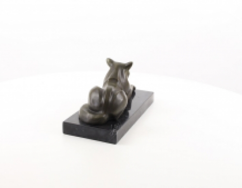 A bronze statue/sculpture of a lying cat, modernist style