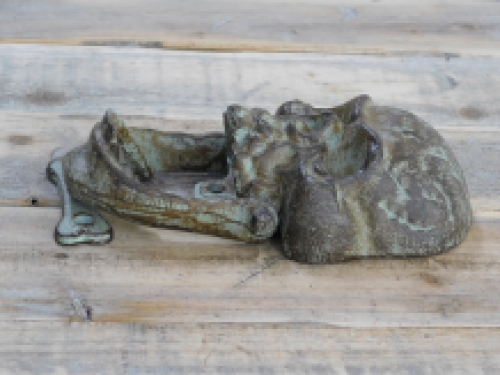 Cast iron green-brown skull as a door knocker.