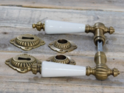 Set of door handles with rosettes - patinated brass 