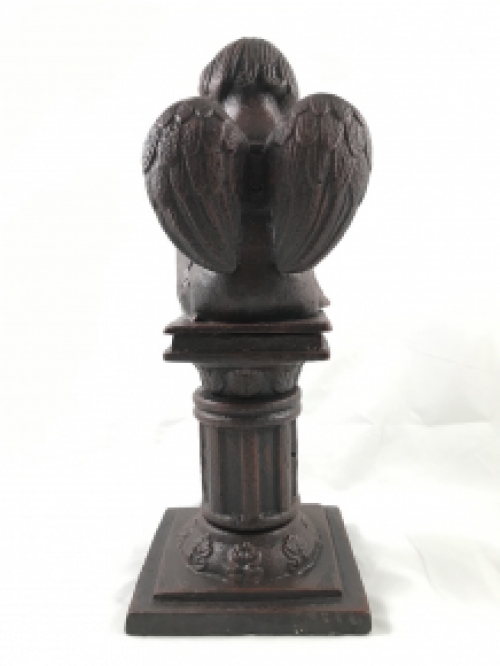 Intact statue of an angel sitting on a pedestal writing, cast iron