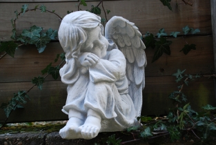 Beautiful sitting angel, full of detail, full of stone.