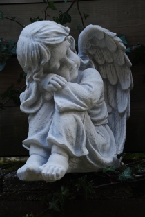 Beautiful sitting angel, full of detail, full of stone.