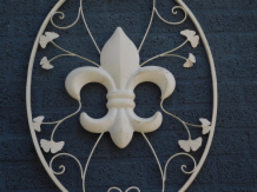 A large wrought iron wall ornament, the French Lily, antique-white