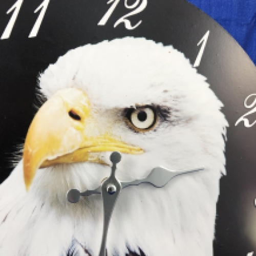 Wooden clock with an image of an eagle.