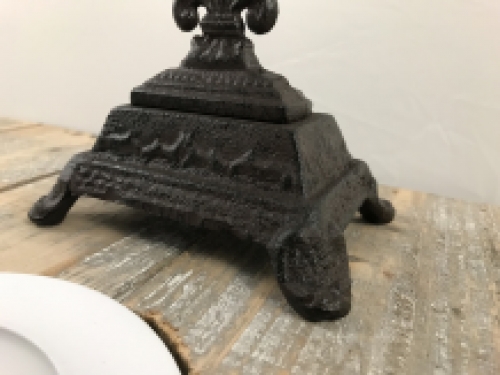 A cross on a stand made of cast iron