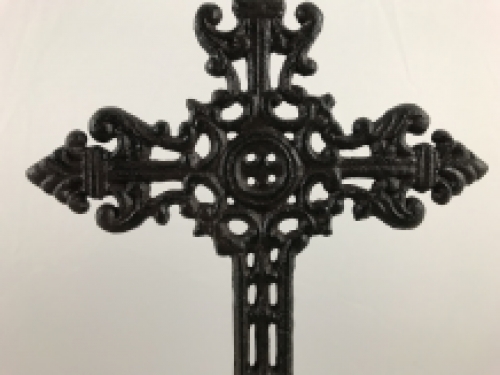 A cross on a stand made of cast iron