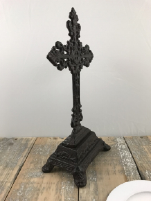 A cross on a stand made of cast iron