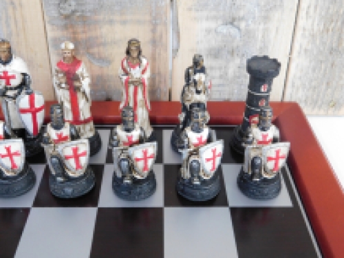 A chess game with the theme: ''MEDIEVAL KNIGHTS'', beautiful chess pieces like medieval knights on a wooden chessboard.