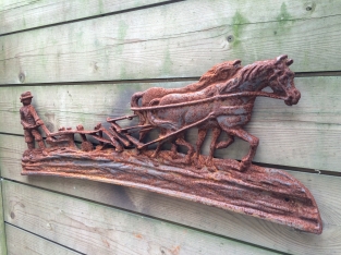 Wall decoration , cast iron fireplace plate farmer with horse and plow.