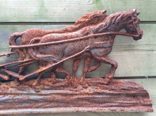 Wall decoration , cast iron fireplace plate farmer with horse and plow.