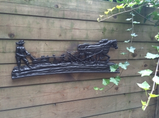 Wall decoration , cast iron black fireplace plate farmer with horse and plow.