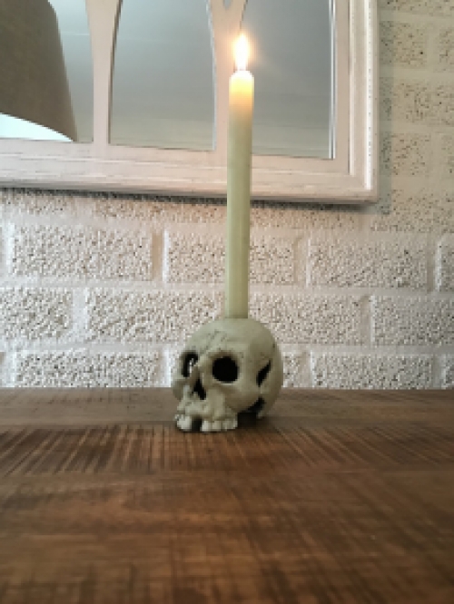 Skull as a candlestick, candle holder as a skull