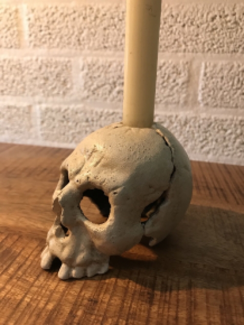 Skull as a candlestick, candle holder as a skull