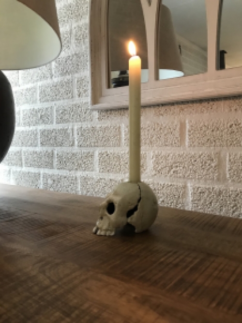 Skull as a candlestick, candle holder as a skull