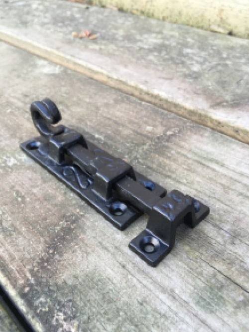 A beautiful door latch / slide lock, matte black, made of wrought iron