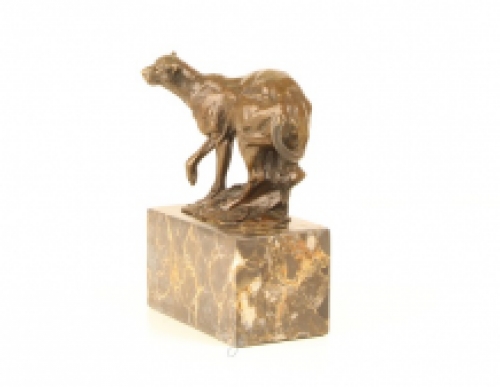 A bronze statue/sculpture of a running puma