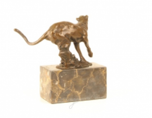 A bronze statue/sculpture of a running puma