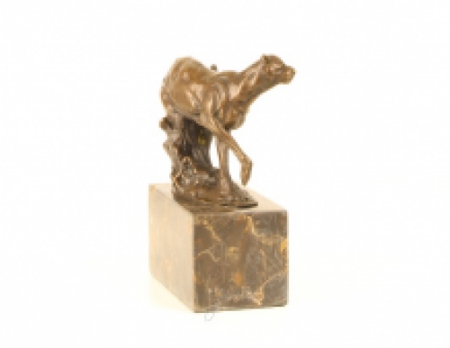 A bronze statue/sculpture of a running puma