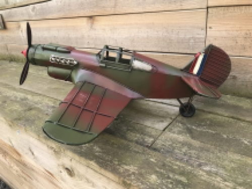 A metal scale model of a fighter plane