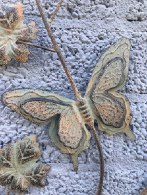 A metal wall ornament with leaves and butterflies, very decorative!