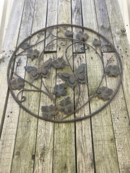 A metal wall ornament with leaves and butterflies, very decorative!