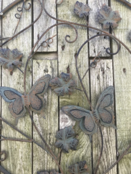 A metal wall ornament with leaves and butterflies, very decorative!