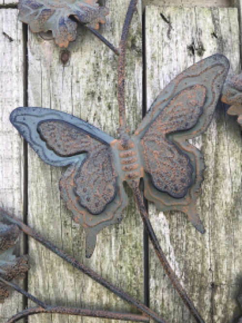 A metal wall ornament with leaves and butterflies, very decorative!