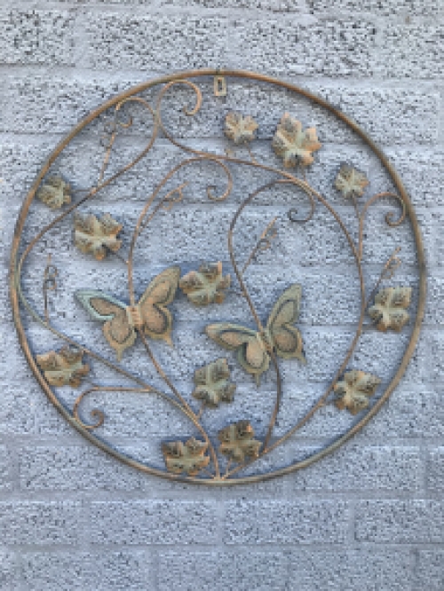 A metal wall ornament with leaves and butterflies, very decorative!